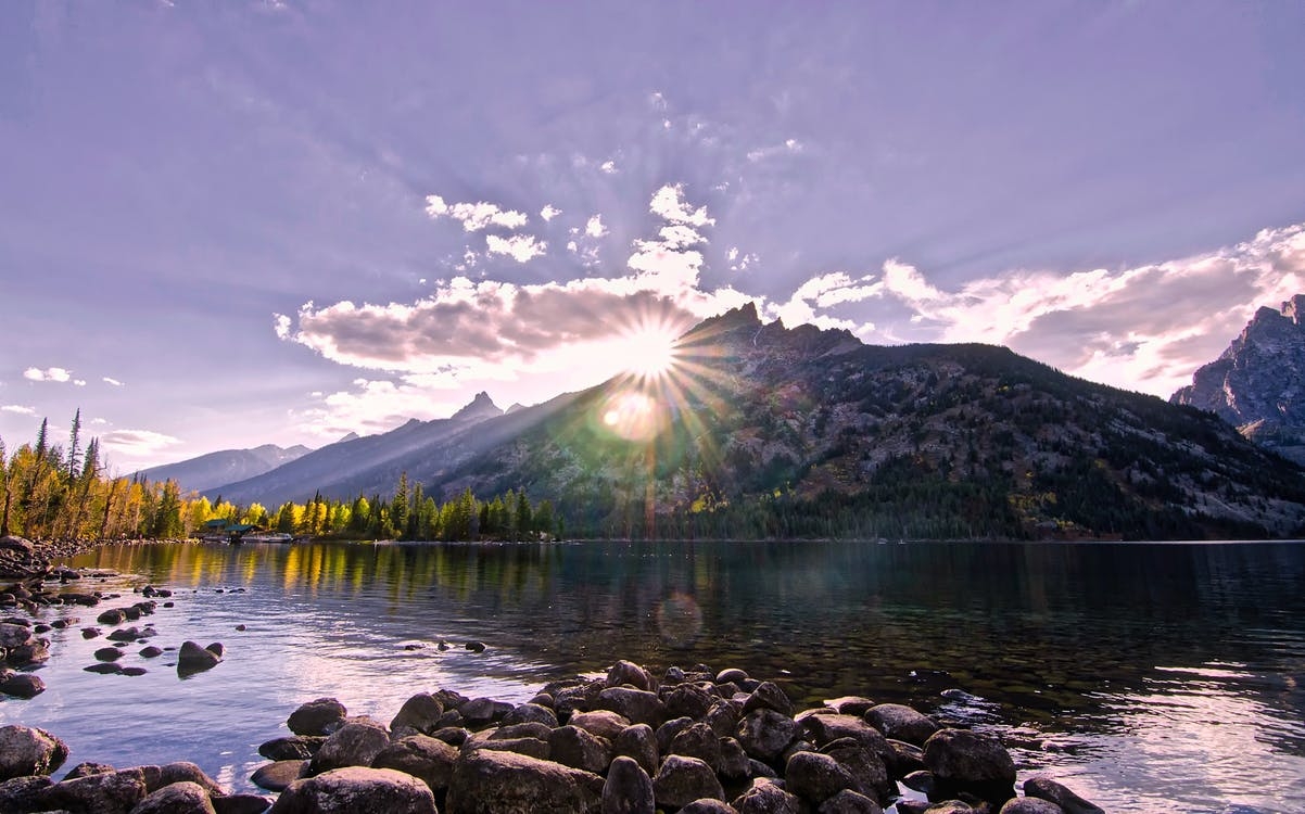 https://www.pexels.com/photo/scenic-view-of-lake-by-mountains-against-sky-at-night-248807/