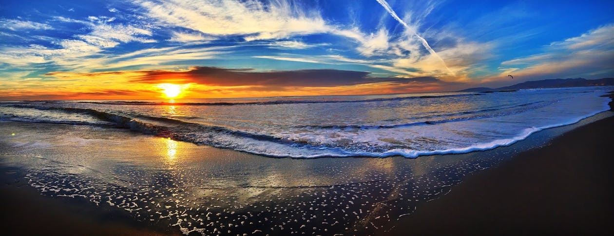 https://www.pexels.com/photo/body-of-water-near-brown-soil-under-blue-sky-during-sunset-128458/