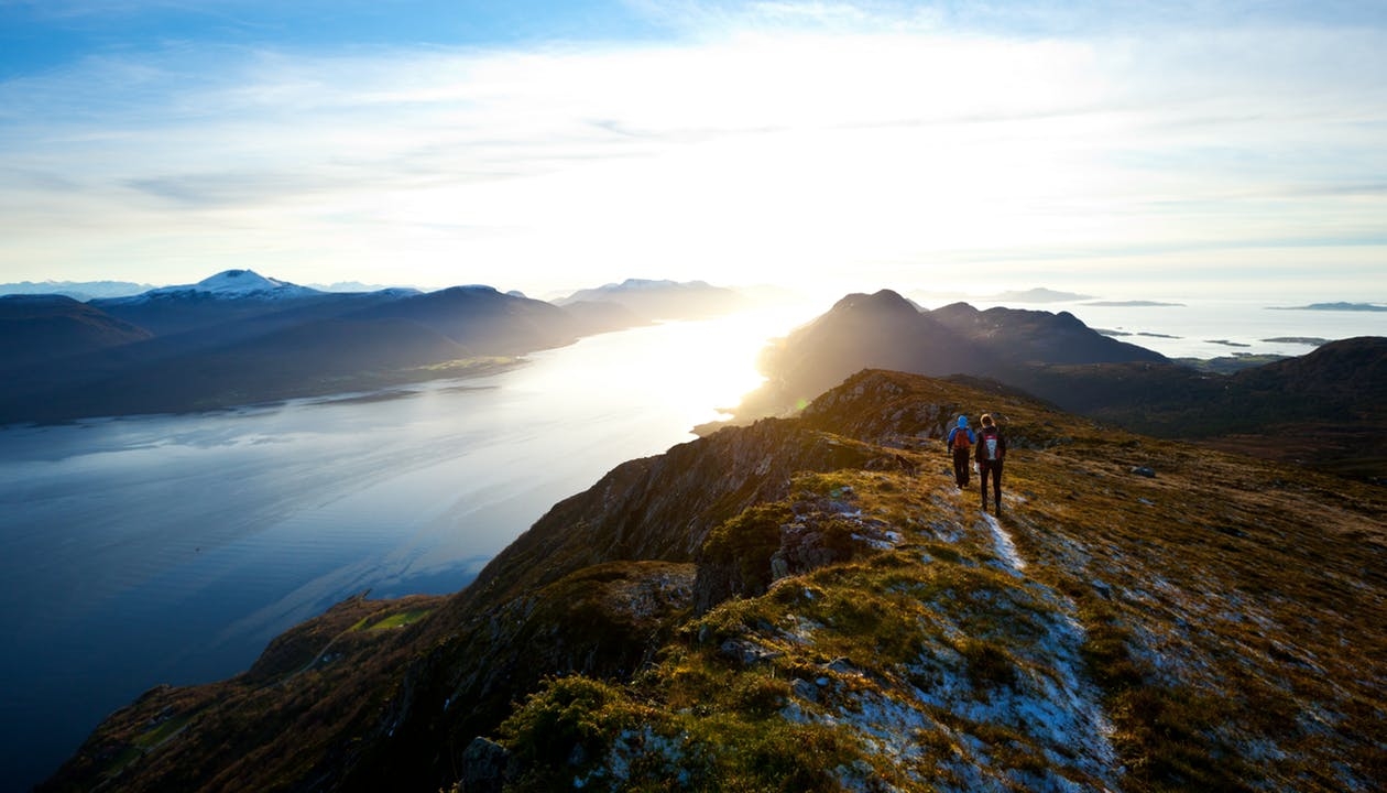 https://www.pexels.com/photo/lake-mountain-hikers-sunset-7861/